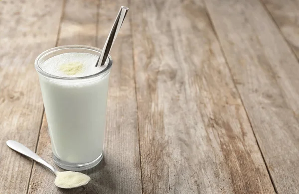 Glass with protein shake and powder