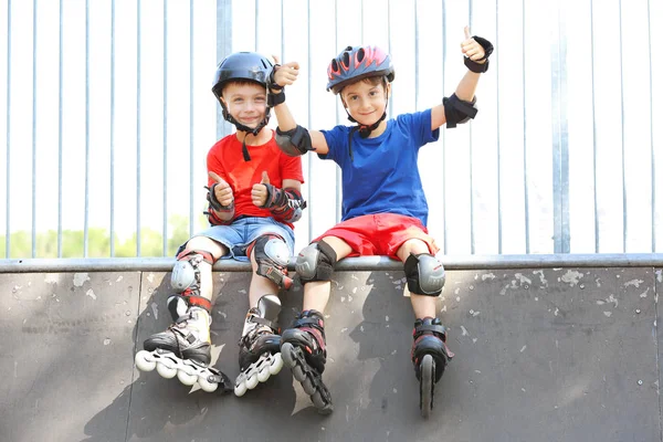 Cute boys on rollers at skate park — Stock Photo, Image
