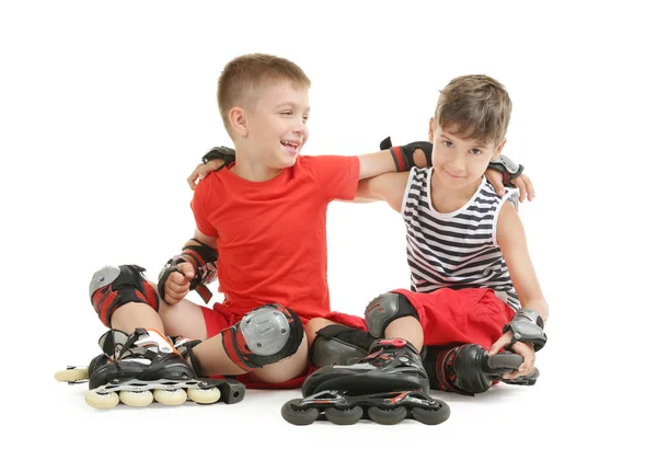 Cute children on roller skates against white background — Stock Photo, Image