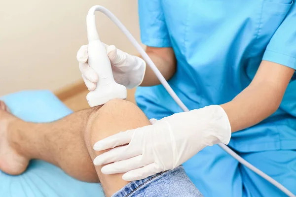 Doctor conducting ultrasound examination — Stock Photo, Image