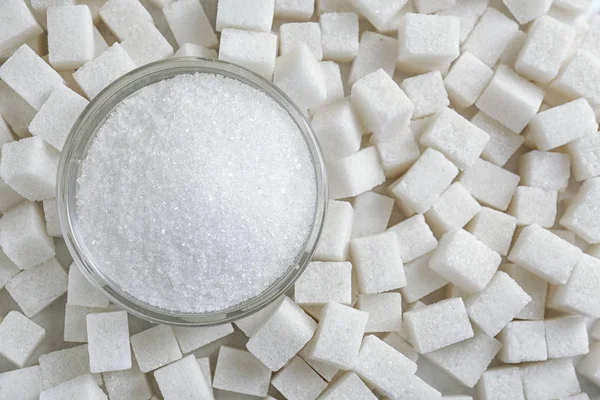 Granulated sugar in jar on sugar cubes — Stock Photo, Image