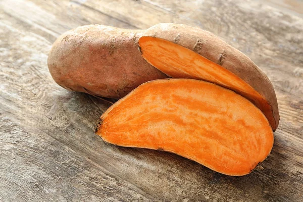 Sweet potatoes on wooden table — Stock Photo, Image