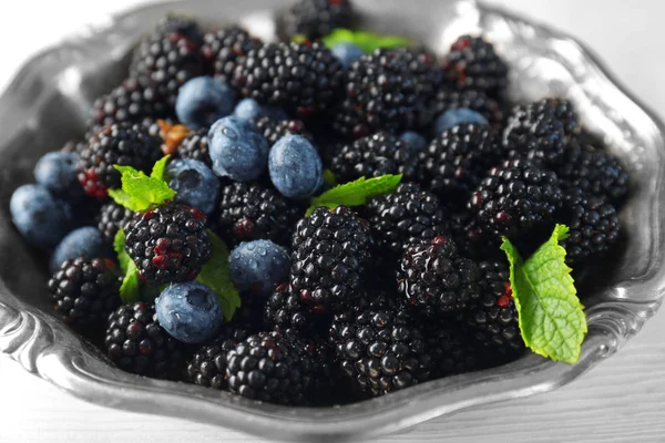 Ripe blackberries and blueberries in bowl Stock Picture