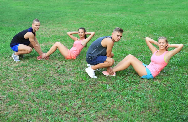 Group of young people doing exercise outdoor — Stock Photo, Image