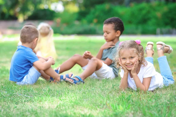 Niedliche kleine Kinder spielen auf grünem Gras — Stockfoto