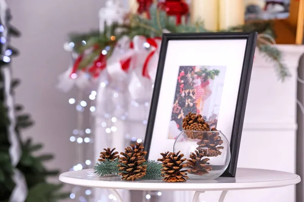 Table with Christmas decorations in room — Stock Photo, Image