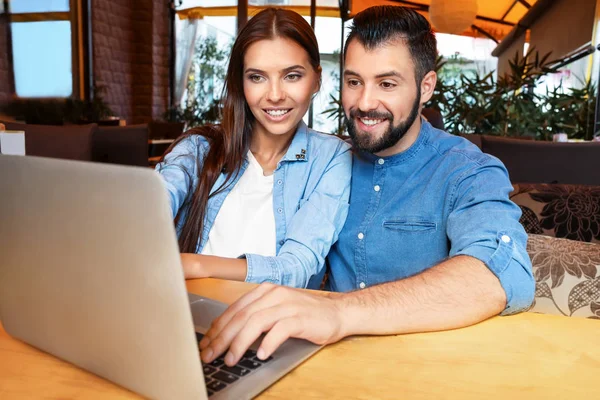 Pasangan muda dengan laptop di kafe. Konsep belanja internet — Stok Foto