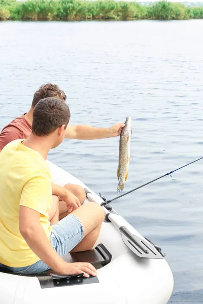Két Férfi Frissen Fogott Halakat Fogyaszthatnak Riverside Felfújható Csónak — Stock Fotó