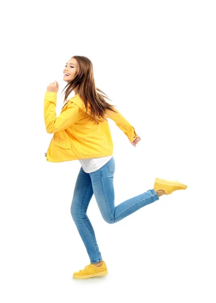 Young woman running on white background — Stock Photo, Image