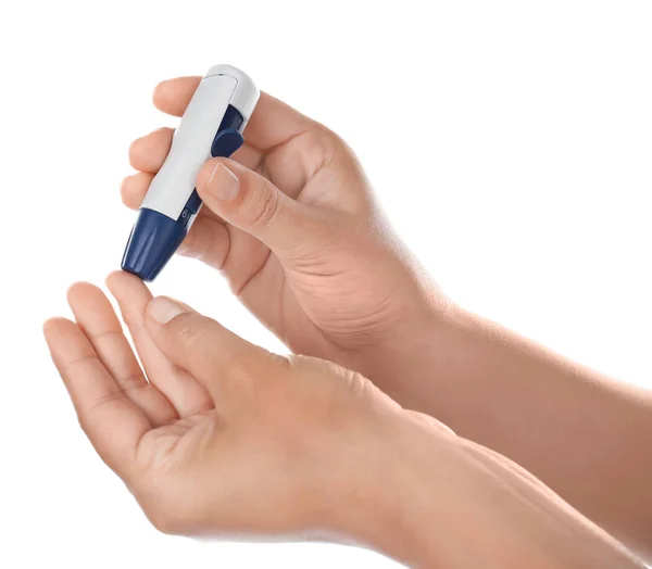 Woman taking blood sample with lancet pen — Stock Photo, Image