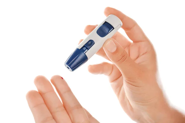 Woman taking blood sample with lancet pen — Stock Photo, Image