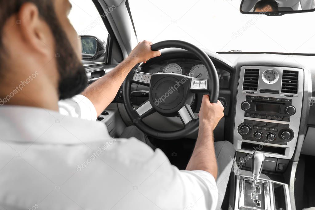 Man on driver's seat of car