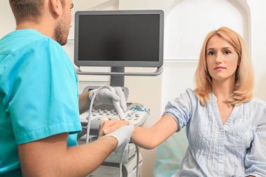 Hastanın bilek iletken ultrason muayenesi kliniğinde doktor