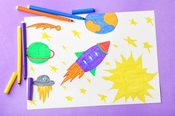 Child's drawing of rocket in space on violet background — Stock Photo, Image