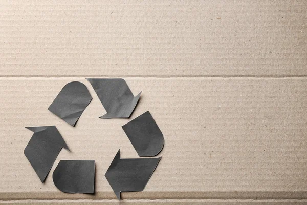 Symbol of recycling on cardboard background