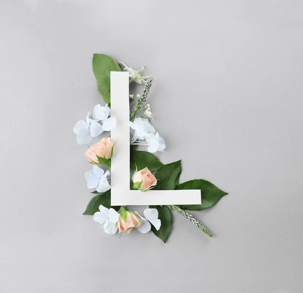 Samenstelling met letter L en mooie bloemen — Stockfoto