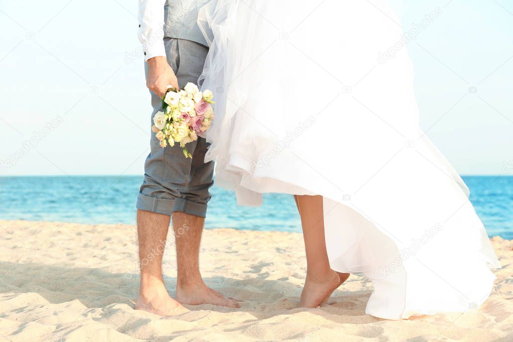 Happy wedding couple on sea beach