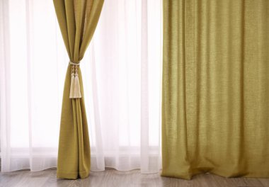Beautiful curtains with tieback indoors clipart