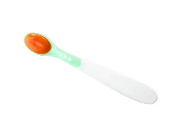 Plastic spoon with baby food — Stock Photo, Image