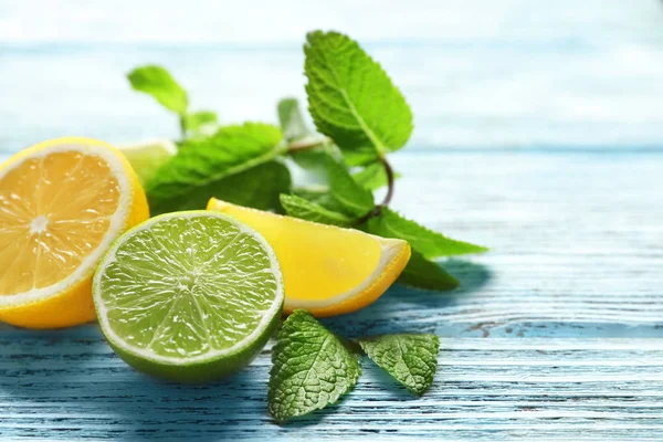 Composition with citrus fruits and mint on wooden background — Stock Photo, Image