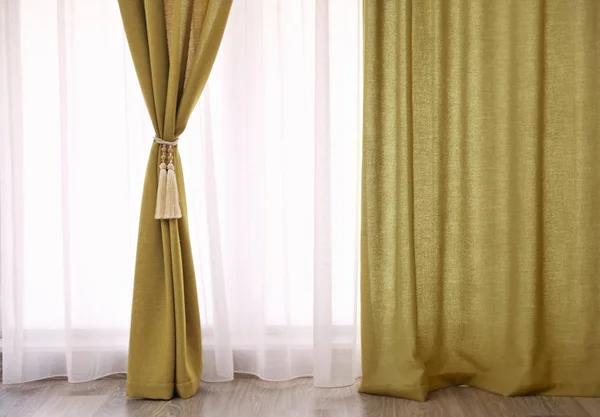 Beautiful curtains with tieback indoors — Stock Photo, Image