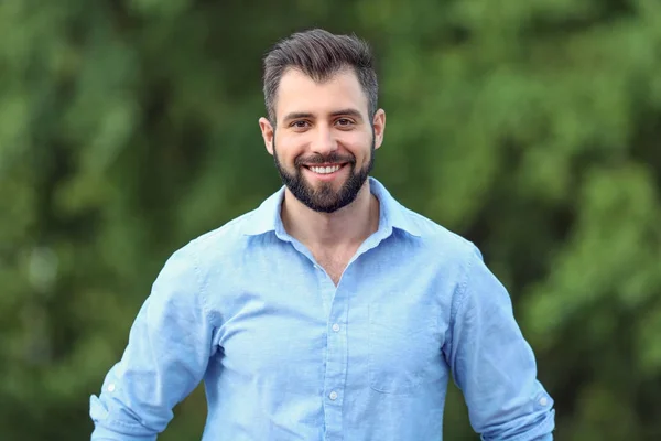 Handsome man in green park — Stock Photo, Image