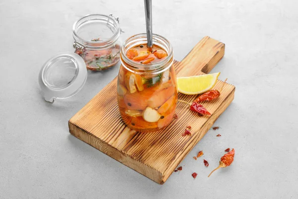 Jar with delicious marinated salmon on table — Stock Photo, Image