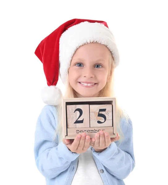 Linda chica en sombrero de Santa con calendario sobre fondo blanco. Concepto de cuenta atrás de Navidad — Foto de Stock