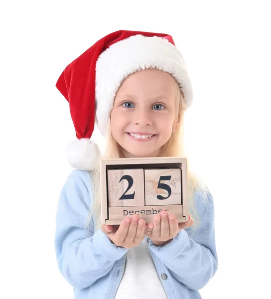 Niedliches Mädchen mit Weihnachtsmütze mit Kalender auf weißem Hintergrund. Weihnachts-Countdown-Konzept — Stockfoto