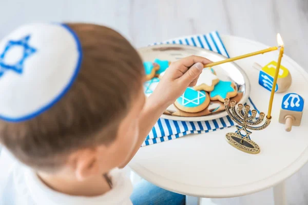 Menorah menino judeu relâmpago em casa — Fotografia de Stock