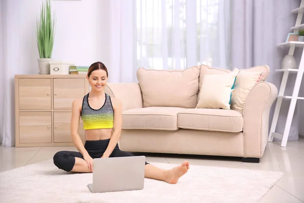 Young beautiful woman training at home