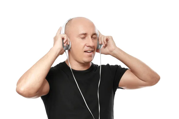 Bald man in black t-shirt listening to music on white background — Stock Photo, Image