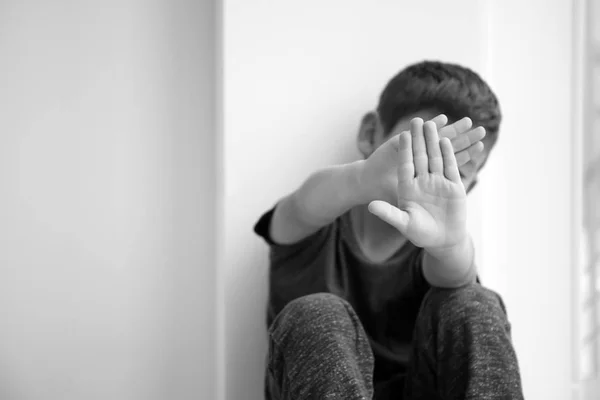 Little boy hiding face indoors. Domestic violence concept — Stock Photo, Image