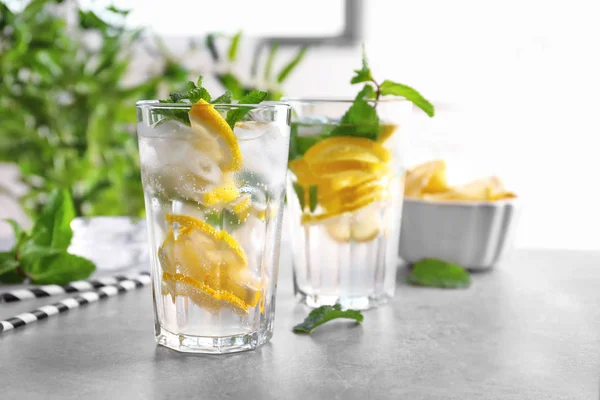 Glasses of cocktail with mint and lemon on table — Stock Photo, Image