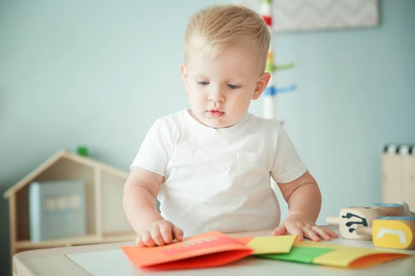 Cute boy with handmade greeting card at home — Stock Photo, Image