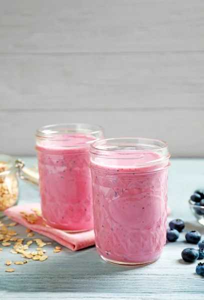 Jars with berry protein shakes