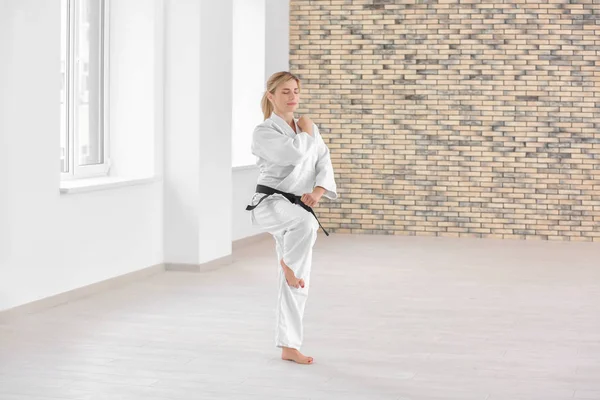 Female karate instructor training in dojo