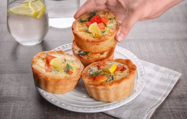 Lezzetli somon tartlets plaka üzerine koyarak kadın