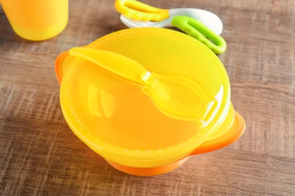 Bright baby dishware on table — Stock Photo, Image