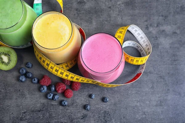 Glasses with different protein shakes on table — Stock Photo, Image