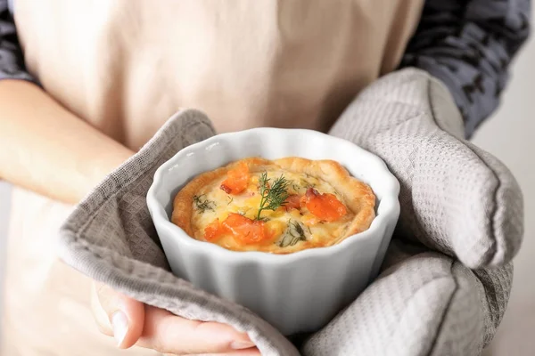 Donna che tiene il ramekin con gustosa tartelletta di salmone — Foto Stock