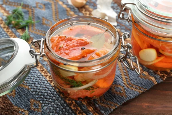 Jar with delicious marinated salmon — Stock Photo, Image