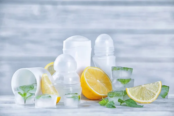 Deodorants for women, lemons and mint on table — Stock Photo, Image