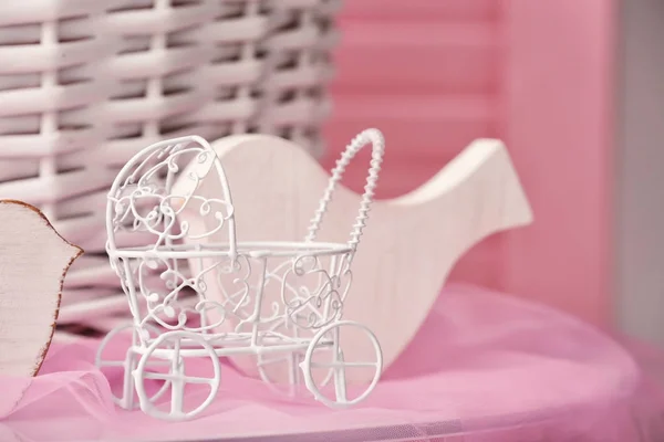 Toy baby carriage on table — Stock Photo, Image