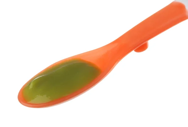 Plastic spoon with baby food — Stock Photo, Image
