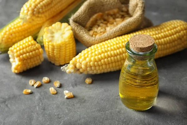 Glass jar with corn oil — Stock Photo, Image