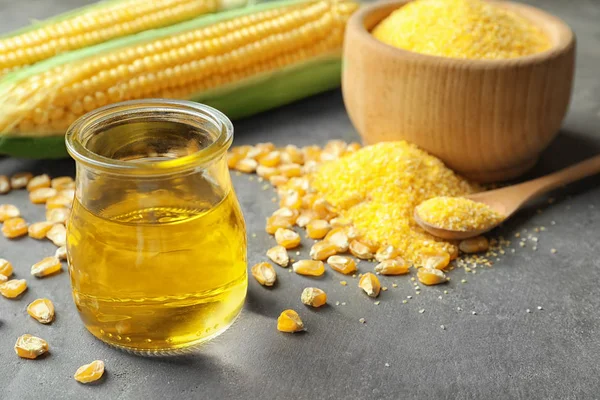 Glass jar with corn oil — Stock Photo, Image