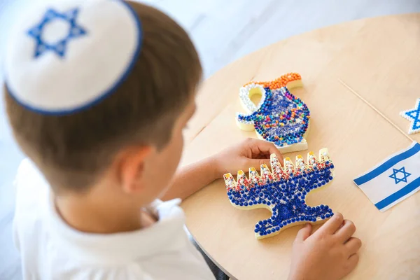 Boy with handmade nine-branched menorah at home — Stock Photo, Image