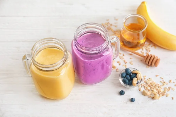 Jars with different protein shakes — Stock Photo, Image