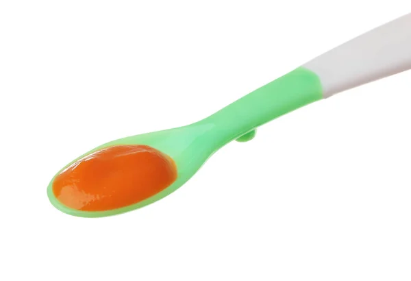 Plastic spoon with baby food — Stock Photo, Image